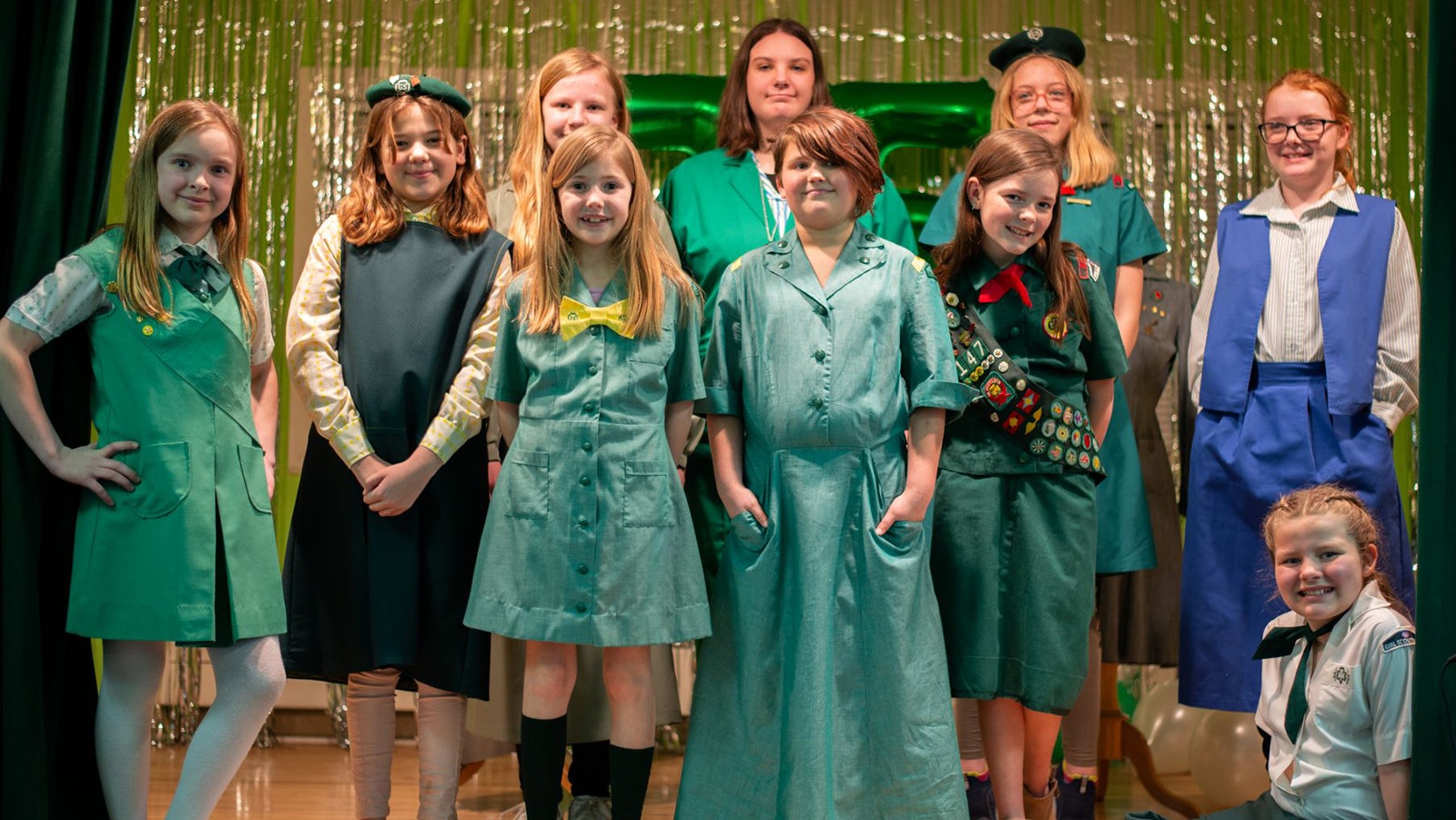 Members of the Cody Girl Scouts dressed in uniforms throughout the years as part of the fashion show during the event.