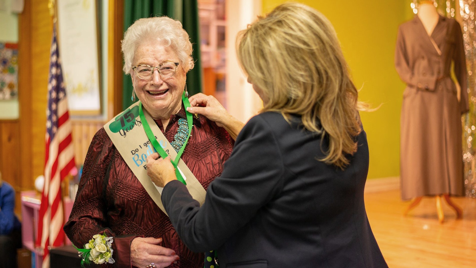 Bettie Marie Daniels receives her 75th year pin from Sally Leep, CEO for the Girl Scouts of Montana and Wyoming, on March 2 in Cody during a celebration for Daniels' many years of service.