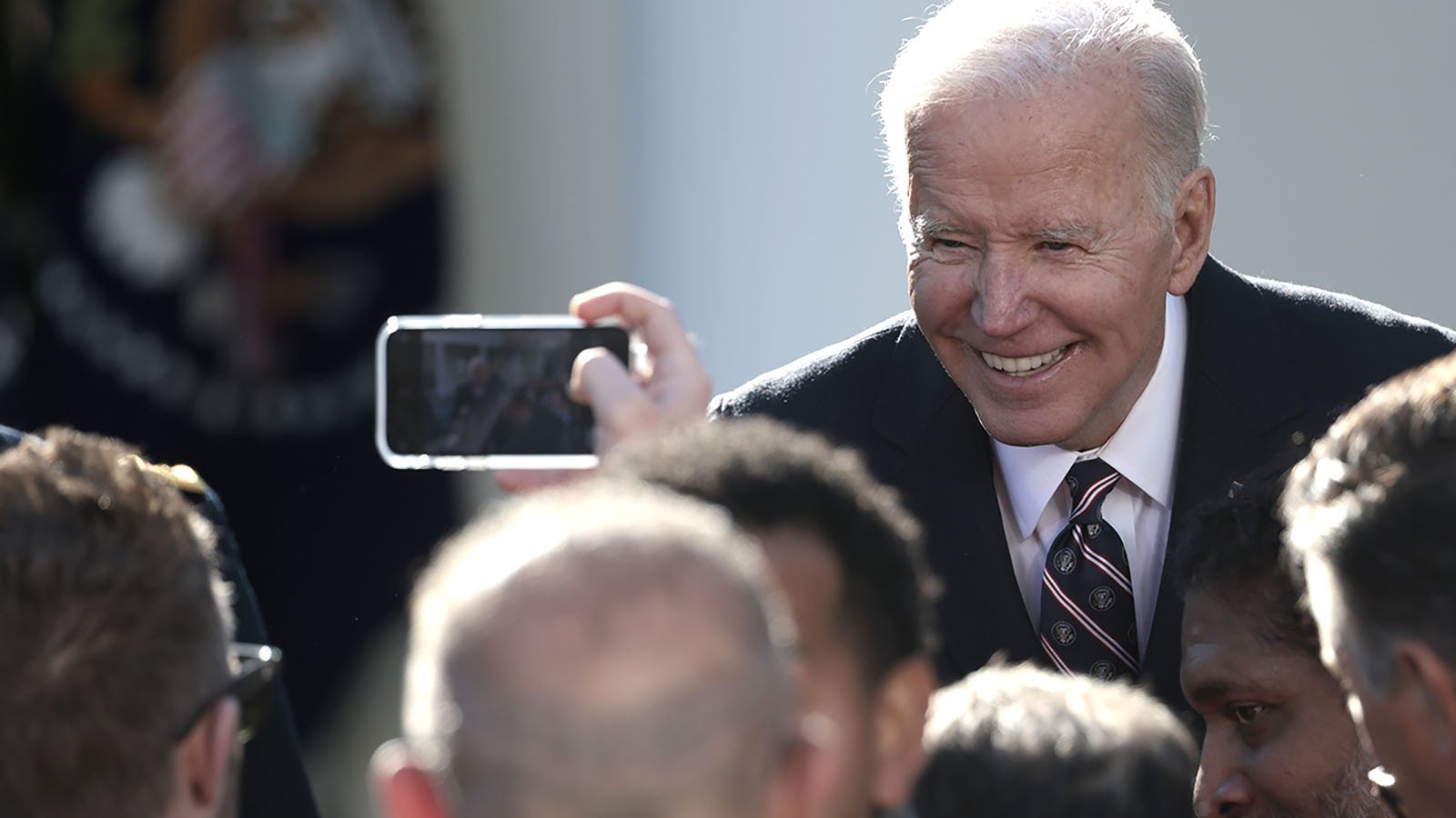 Biden smiles for cellphone pic 7 11 23