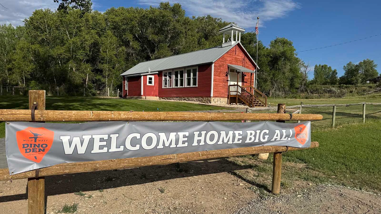 A banner welcoming the arrival of Big Al the Allosaurus to the Historic Red Shell Schoolhouse.
