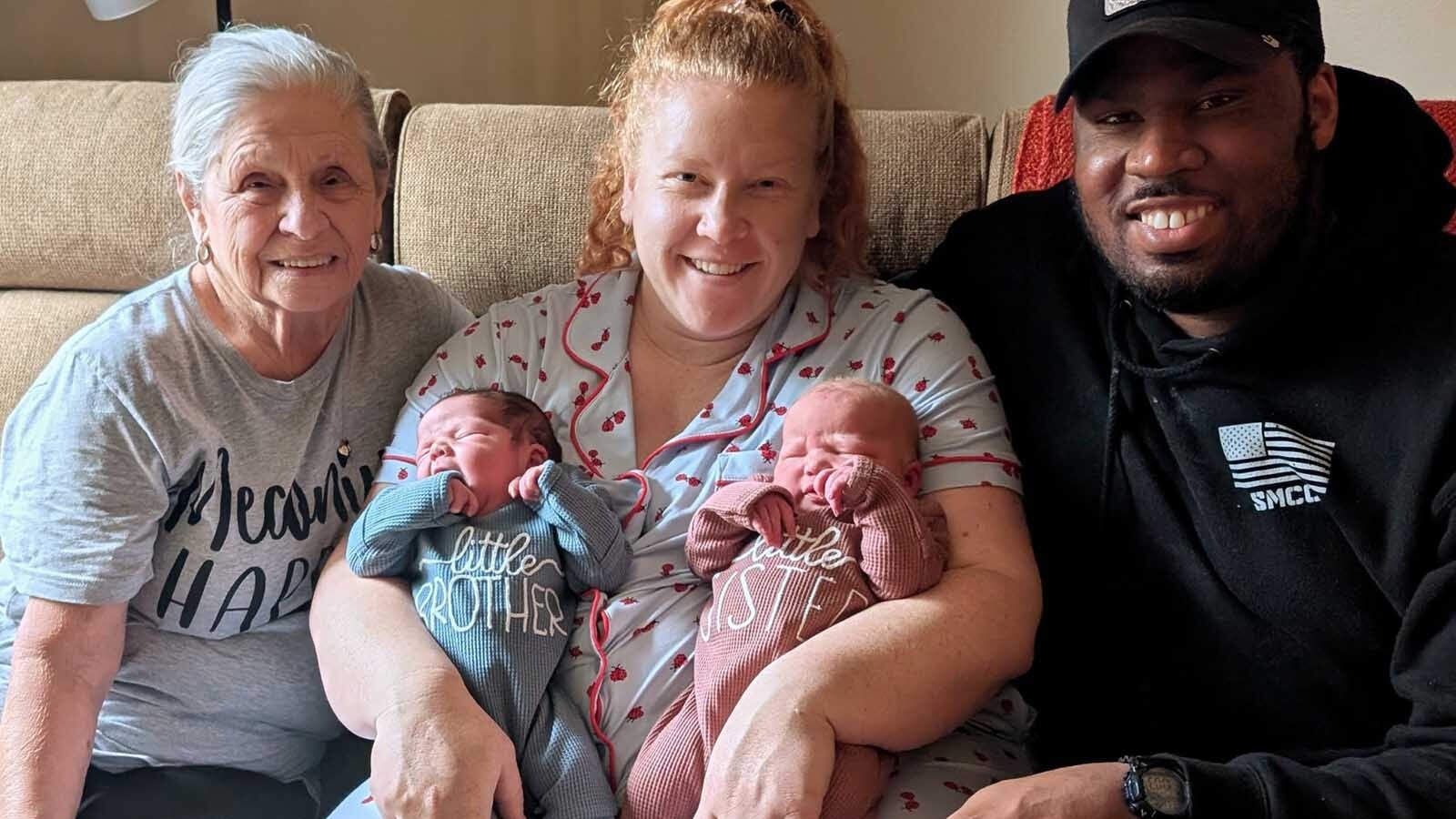Chris Miller and Hope and Raleigh Henderson pose with the new babies after their birth.
