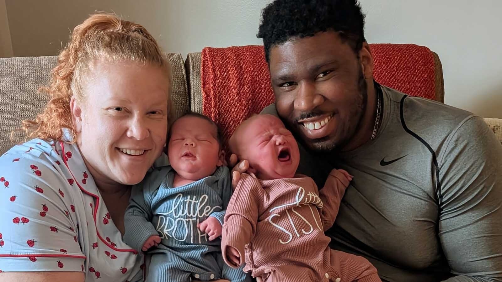 Hope and Raleigh Henderson cuddle with their latest additions to their family.