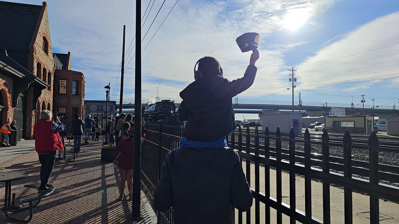Weston Gall, perched on his dad's shoulders, raise his hat as high as he can as Big Boy 4014 arrives in Cheyenne. Gall came up with his parents from Colorado, but he wasn't the one who traveled furthest. There was a couple from Denmark who specifically came to Cheyenne to see Big Boy off.