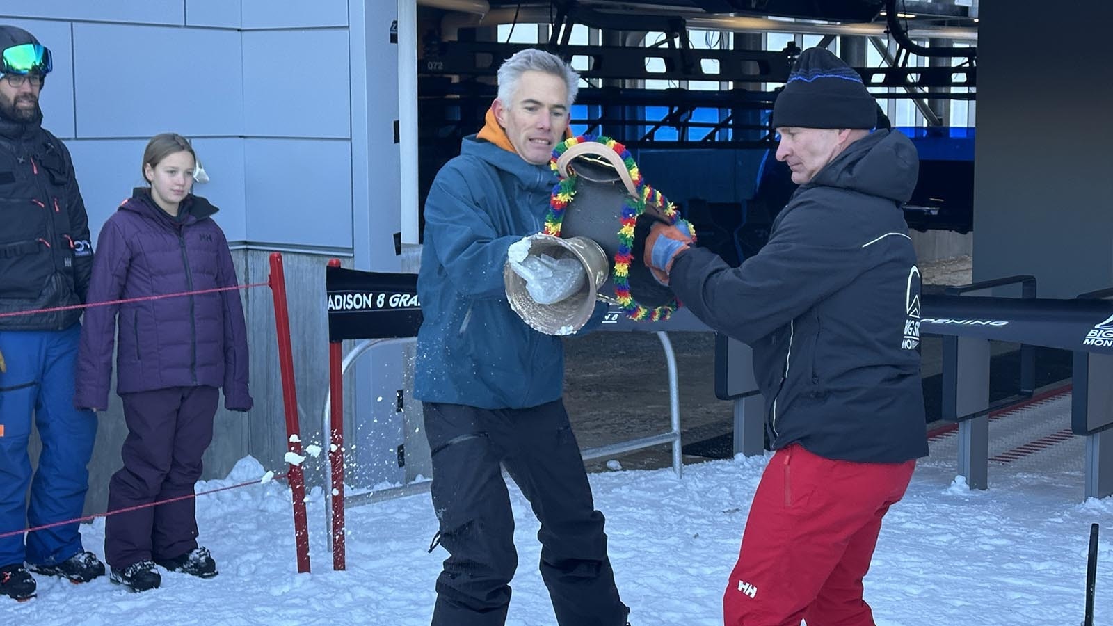 Big Sky Resort President and COO Troy Nedved and Lone Mountain Land Company President Matt Kidd ring the traditional Doppelmayr bell, given as a gift by the German ski lift company anytime a new Doppelmayr chair opens.