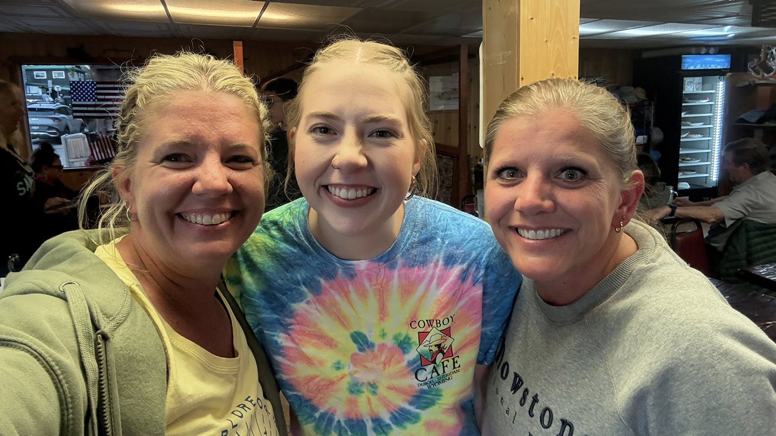 Amber Sessock, center, has worked at the Cowboy Cafe since she was 14. She was the lucky waitress who received a nearly $1,500 in a tip from two best friends from Iowa, Brandi Macumber and Tamara Bane, who are on a tipping mission to celebrate servers.