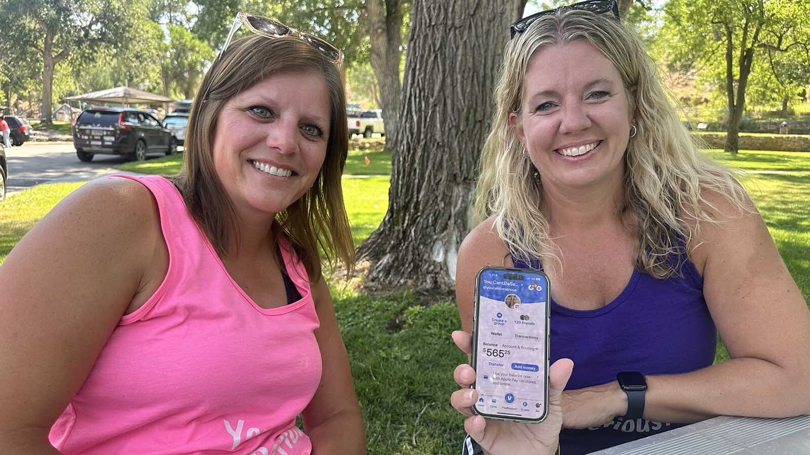 By 11:30 a.m. Saturday, Tamara Bane, left, and Brandi Macumber had raised over $500. The money will be used to tip their server that night.