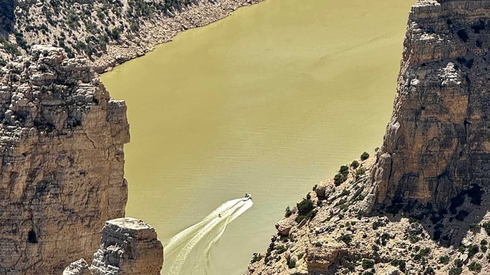 The sheer size of Bighorn Canyon can be seen here as the boat with a trailing skier are just specks in the distance.
