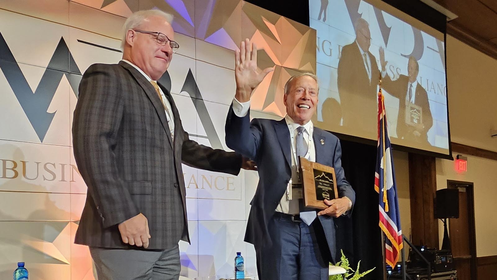 Bill Schilling accepts a plaque recognizing his lifetime achievements in Wyoming from Brent Hathaway. Schilling's signature accomplishments include helping to create the Hathaway Scholarship, named after the late Stan Hathaway, who served two terms as Governor in 1966 and 1970.