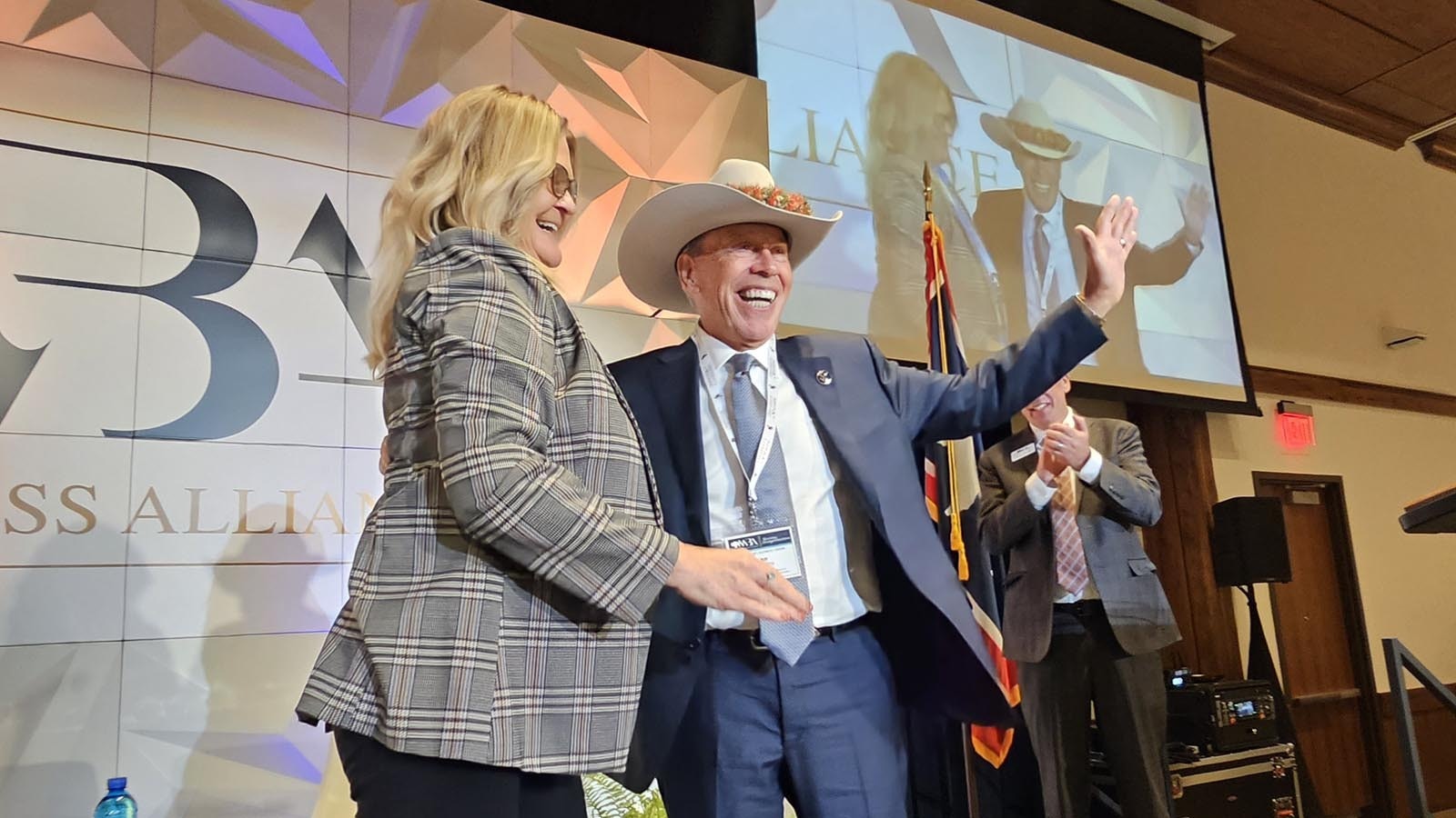 Bill Schilling laughs out loud as he wears a surprise gift from Wyoming. It's a Wyoming cowboy hat with a Hawaiian lei for hat band. Schilling now lives in Hawaii, but came back to be inducted into Wyoming Business Alliance's Hall of Fame for his achievements over four decades, including the Hathaway Scholarship.