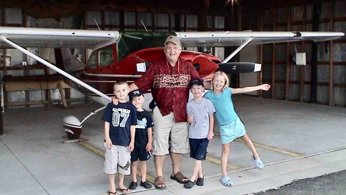 Bill Sniffin with Cessna 182 and grandkids