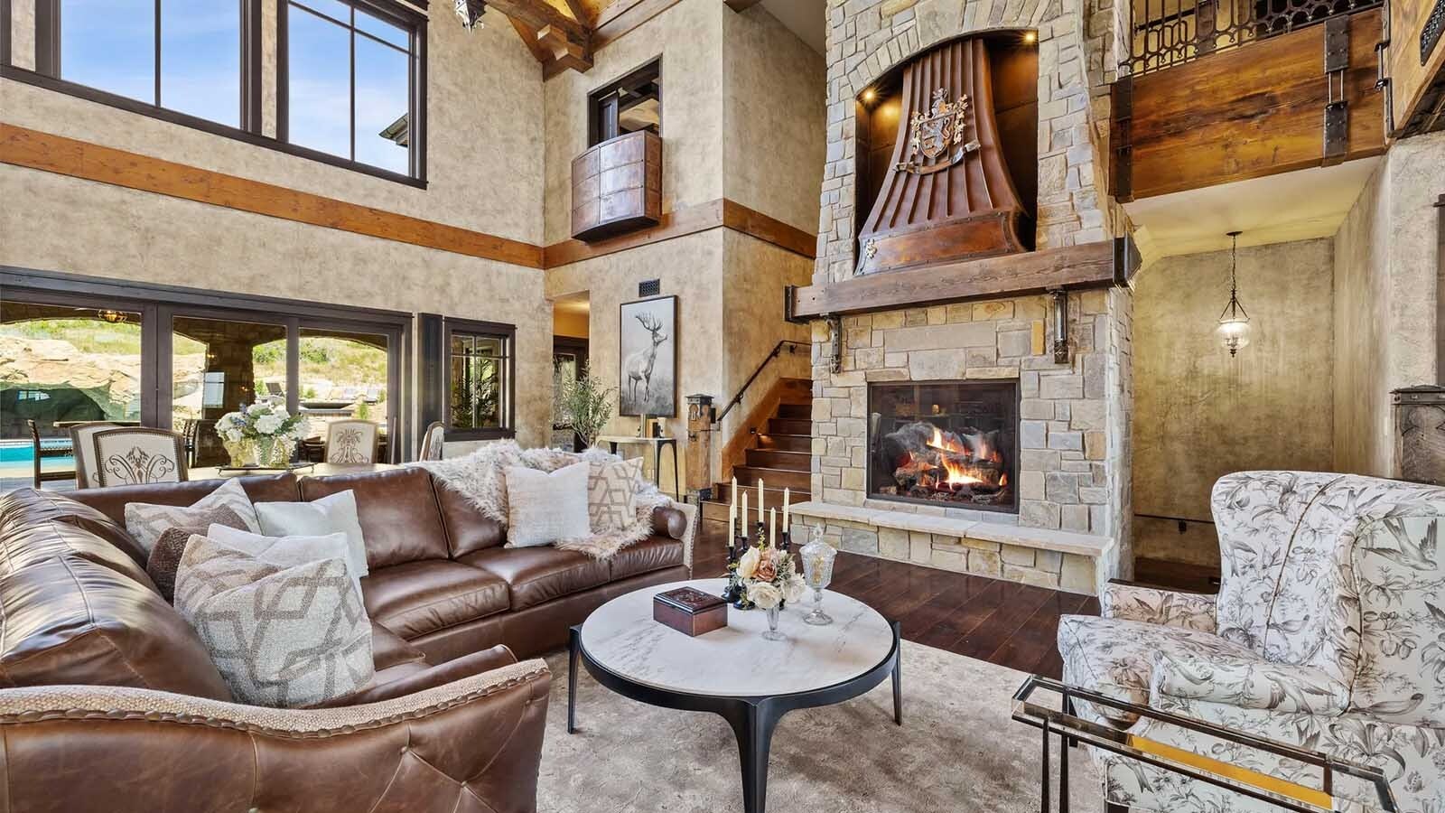 The property at 5650 Canyonwoods Drive in Billings, Montana, is described as a 30,843-square-foot stone chateau with 10 bedrooms and 19 bathrooms, situated on 98 acres. The listing mentions it's priced at $26.9 million and includes amenities like three pools, a 14-car garage, elevators, indoor shooting range, bowling alley, an outdoor 3-hole golf course and an indoor golf simulator, plus a wine cellar, workout gym and theater.