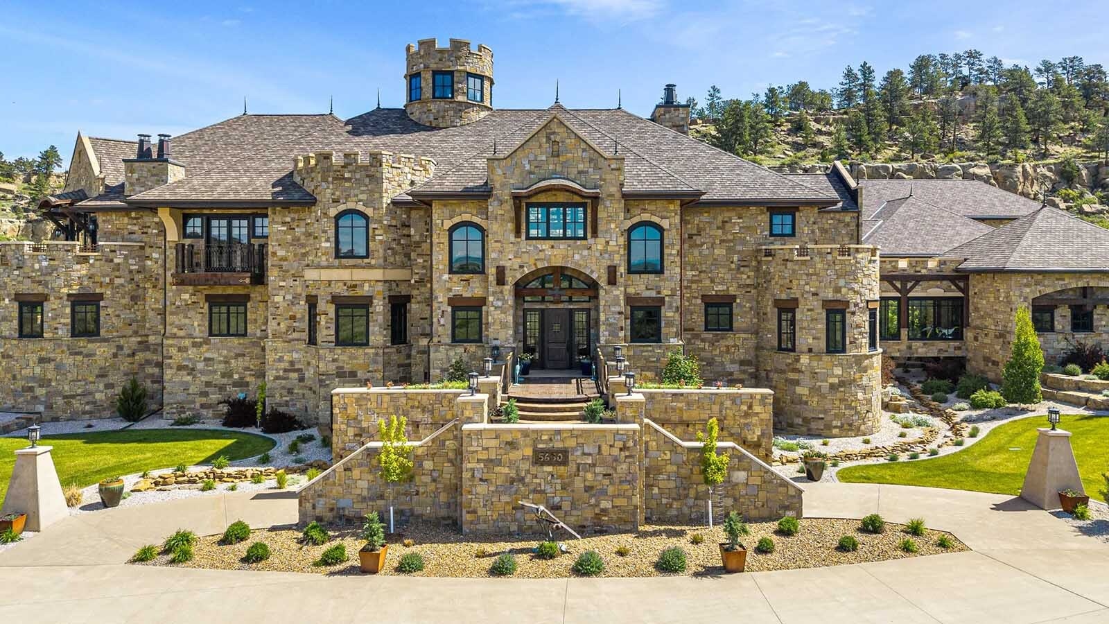 The property at 5650 Canyonwoods Drive in Billings, Montana, is described as a 30,843-square-foot stone chateau with 10 bedrooms and 19 bathrooms, situated on 98 acres. The listing mentions it's priced at $26.9 million and includes amenities like three pools, a 14-car garage, elevators, indoor shooting range, bowling alley, an outdoor 3-hole golf course and an indoor golf simulator, plus a wine cellar, workout gym and theater.