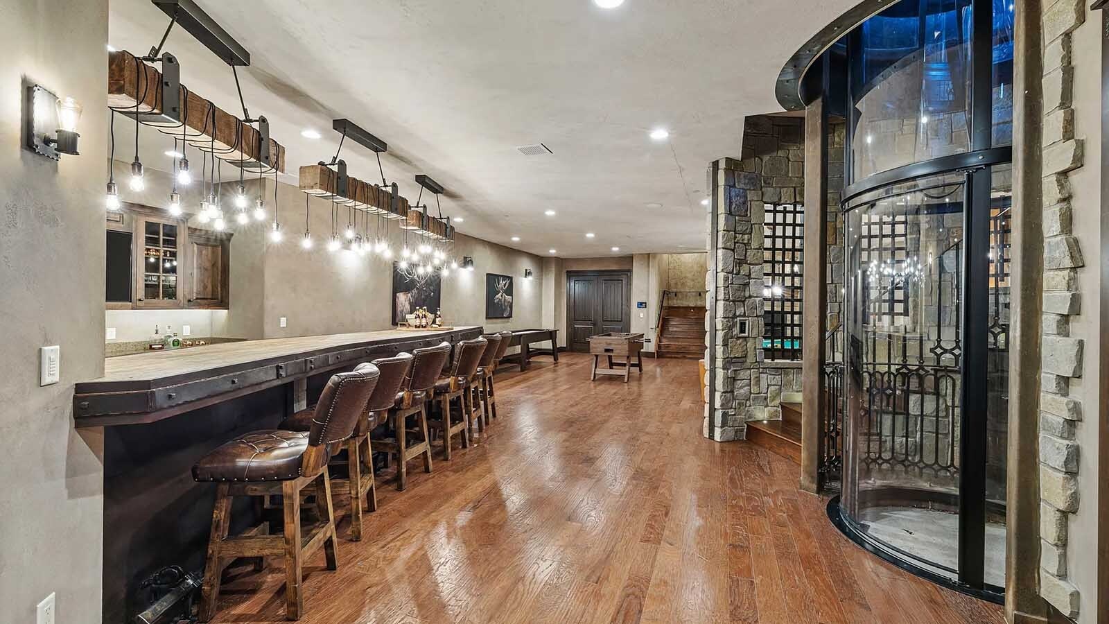 The property at 5650 Canyonwoods Drive in Billings, Montana, is described as a 30,843-square-foot stone chateau with 10 bedrooms and 19 bathrooms, situated on 98 acres. The listing mentions it's priced at $26.9 million and includes amenities like three pools, a 14-car garage, elevators, indoor shooting range, bowling alley, an outdoor 3-hole golf course and an indoor golf simulator, plus a wine cellar, workout gym and theater.