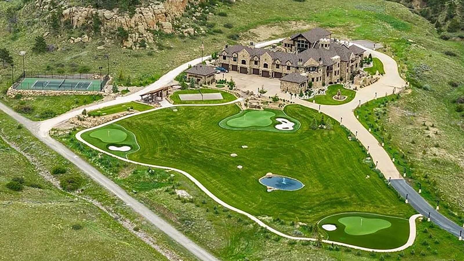 The property at 5650 Canyonwoods Drive in Billings, Montana, is described as a 30,843-square-foot stone chateau with 10 bedrooms and 19 bathrooms, situated on 98 acres. The listing mentions it's priced at $26.9 million and includes amenities like three pools, a 14-car garage, elevators, indoor shooting range, bowling alley, an outdoor 3-hole golf course and an indoor golf simulator, plus a wine cellar, workout gym and theater.