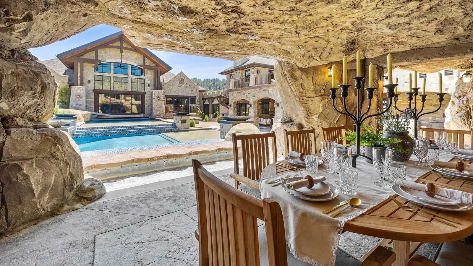 The property at 5650 Canyonwoods Drive in Billings, Montana, is described as a 30,843-square-foot stone chateau with 10 bedrooms and 19 bathrooms, situated on 98 acres. The listing mentions it's priced at $26.9 million and includes amenities like three pools, a 14-car garage, elevators, indoor shooting range, bowling alley, an outdoor 3-hole golf course and an indoor golf simulator, plus a wine cellar, workout gym and theater.