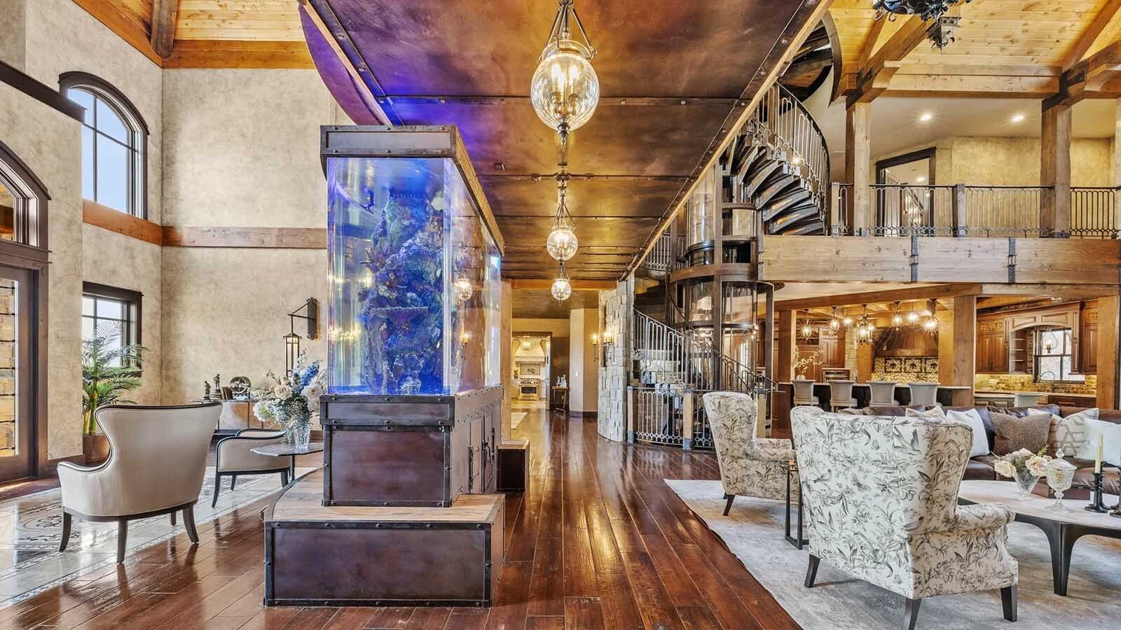 The property at 5650 Canyonwoods Drive in Billings, Montana, is described as a 30,843-square-foot stone chateau with 10 bedrooms and 19 bathrooms, situated on 98 acres. The listing mentions it's priced at $26.9 million and includes amenities like three pools, a 14-car garage, elevators, indoor shooting range, bowling alley, an outdoor 3-hole golf course and an indoor golf simulator, plus a wine cellar, workout gym and theater.