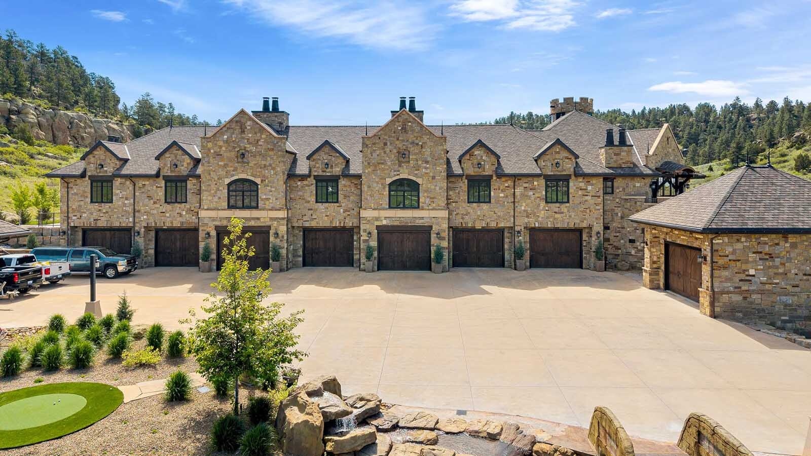 The property at 5650 Canyonwoods Drive in Billings, Montana, is described as a 30,843-square-foot stone chateau with 10 bedrooms and 19 bathrooms, situated on 98 acres. The listing mentions it's priced at $26.9 million and includes amenities like three pools, a 14-car garage, elevators, indoor shooting range, bowling alley, an outdoor 3-hole golf course and an indoor golf simulator, plus a wine cellar, workout gym and theater.