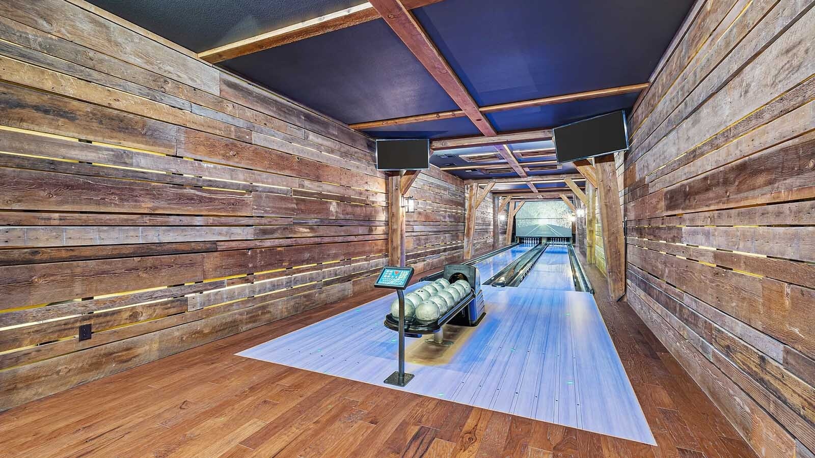 The property at 5650 Canyonwoods Drive in Billings, Montana, is described as a 30,843-square-foot stone chateau with 10 bedrooms and 19 bathrooms, situated on 98 acres. The listing mentions it's priced at $26.9 million and includes amenities like three pools, a 14-car garage, elevators, indoor shooting range, bowling alley, an outdoor 3-hole golf course and an indoor golf simulator, plus a wine cellar, workout gym and theater.