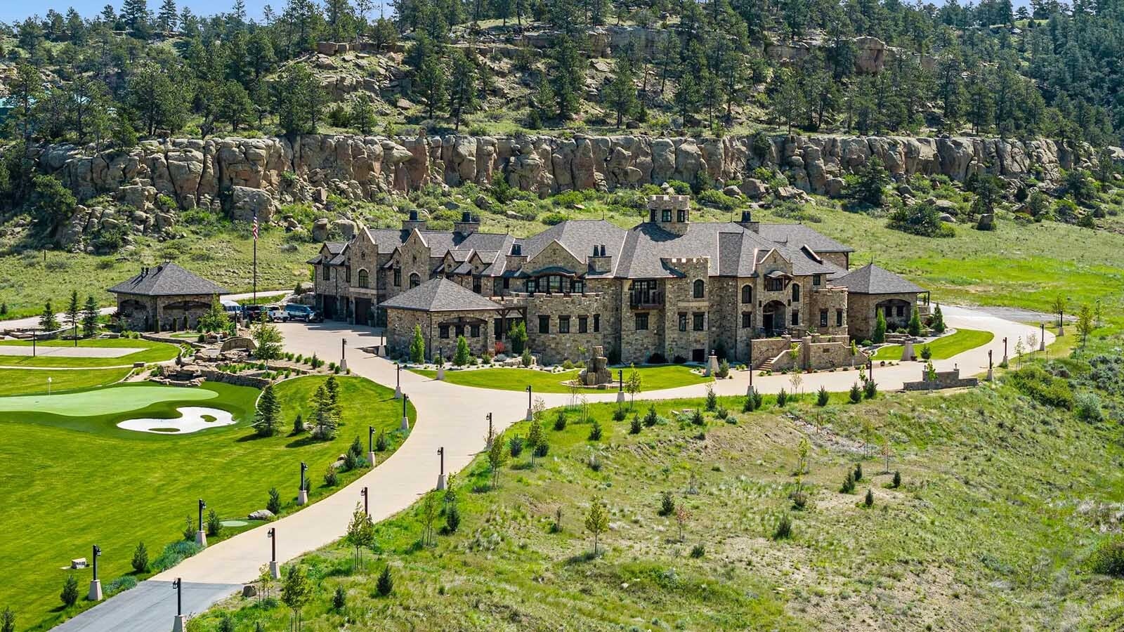 The property at 5650 Canyonwoods Drive in Billings, Montana, is described as a 30,843-square-foot stone chateau with 10 bedrooms and 19 bathrooms, situated on 98 acres. The listing mentions it's priced at $26.9 million and includes amenities like three pools, a 14-car garage, elevators, indoor shooting range, bowling alley, an outdoor 3-hole golf course and an indoor golf simulator, plus a wine cellar, workout gym and theater.