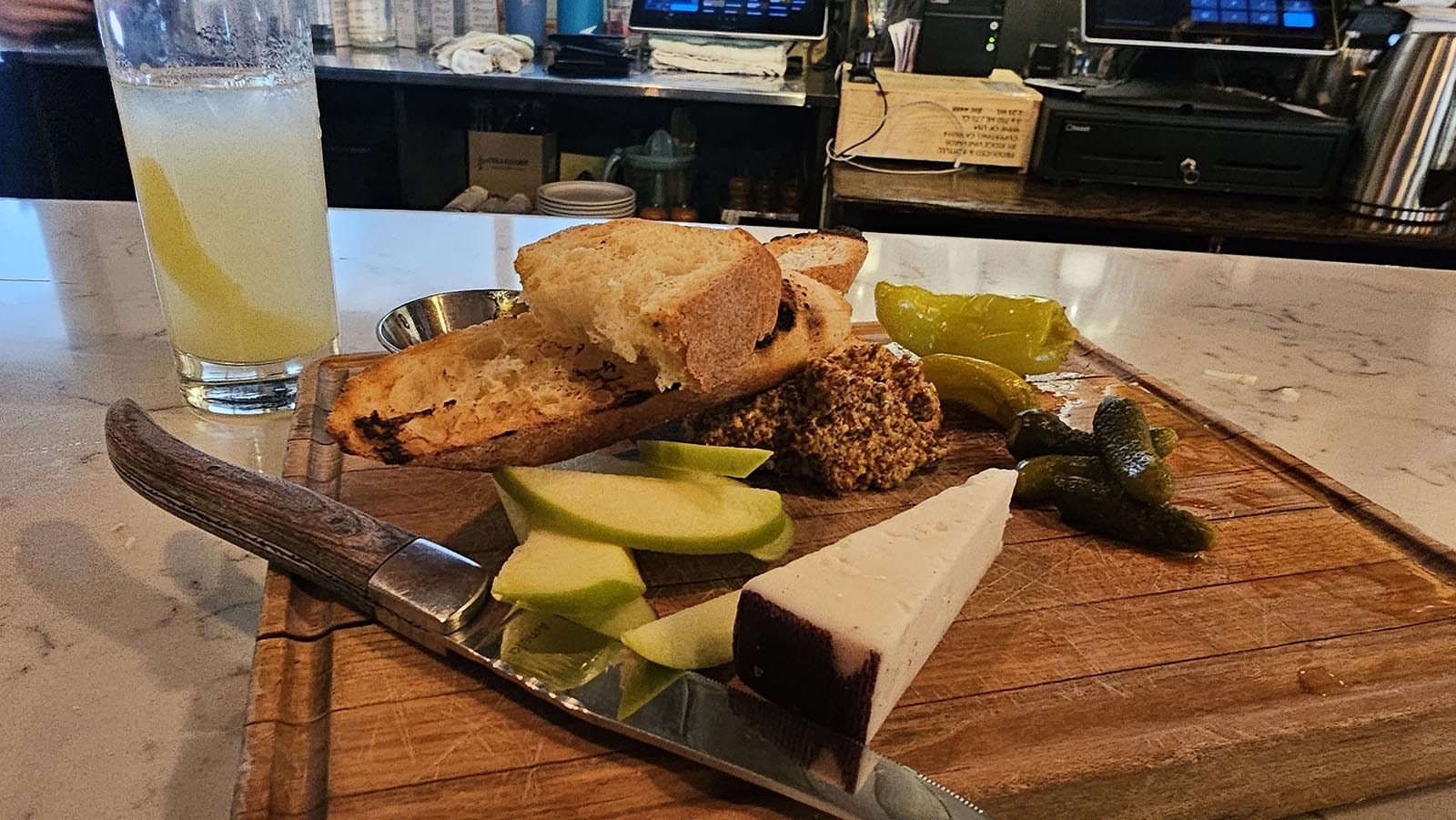 The cheese plates at Bin22 comes with spicy mustard, fig jam, pickles, peppers, bread, and apple slices.