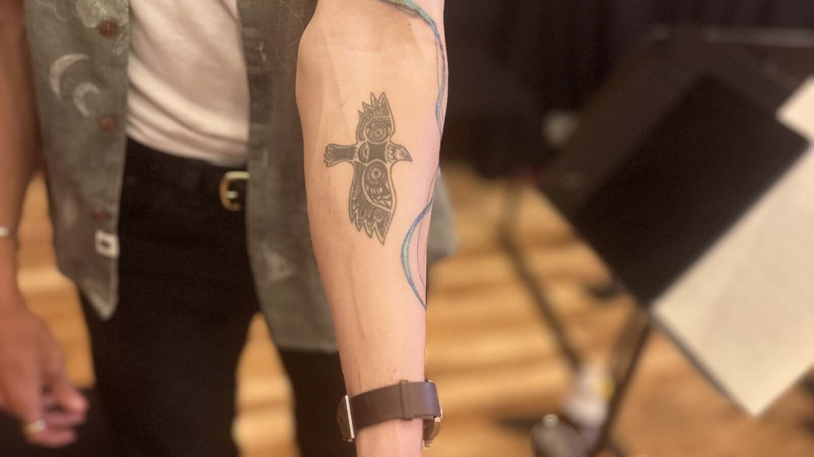 Violinist Miika Gregg’s mythical bird tattoo.