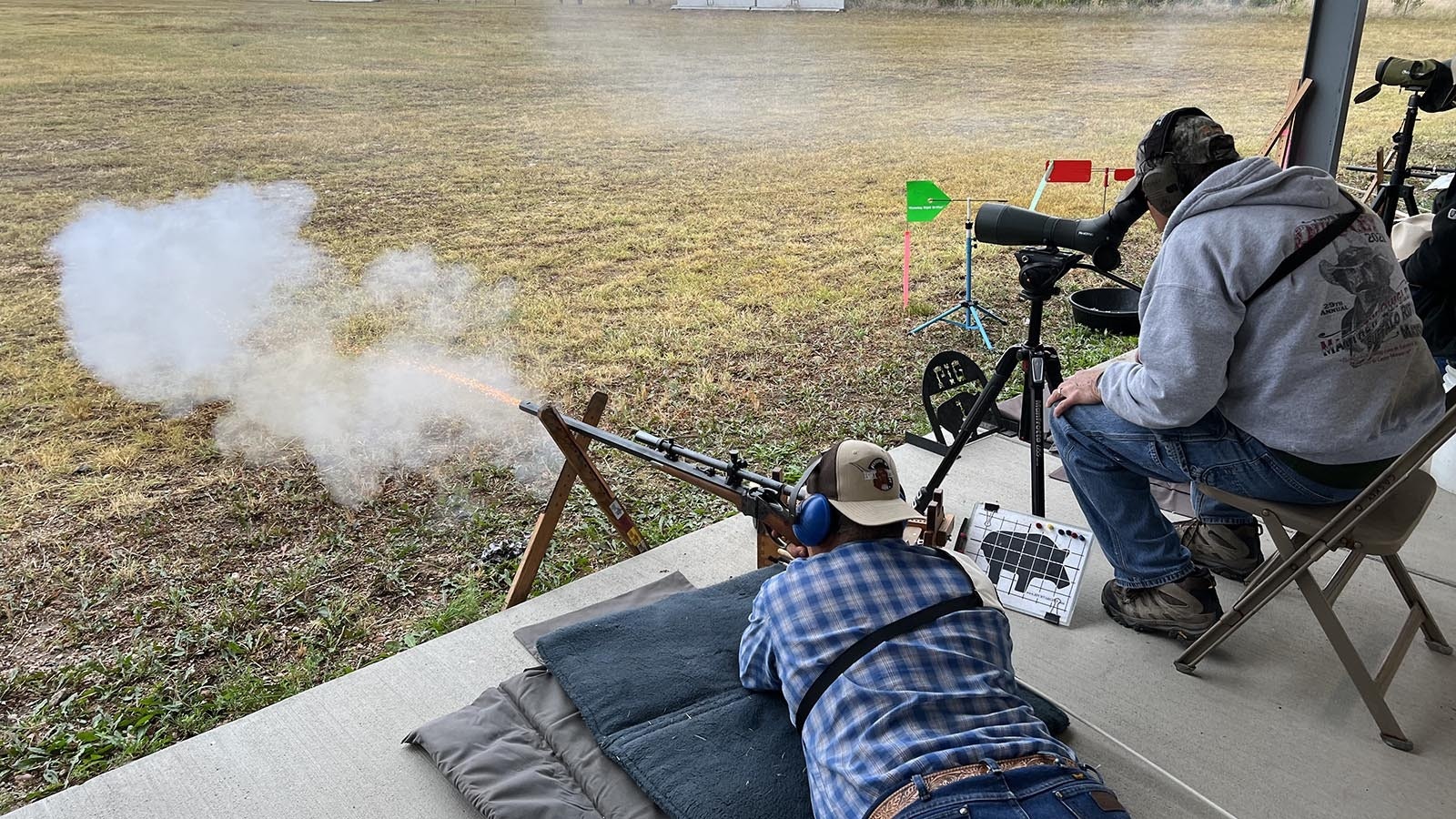 Smoke and sparks burst from the muzzle of an historically authentic black powder cartridge rifle during a shooting match at the Smithmoor BPCR Range near Carpenter on Thursday.