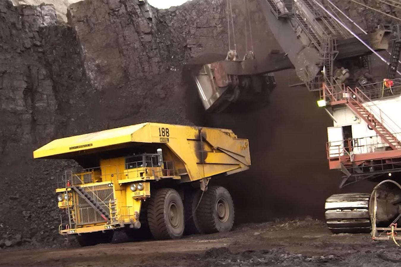 A large coal shovel fills a haul truck at the Black Thunder Mine in Wyoming's Powder River Basin.