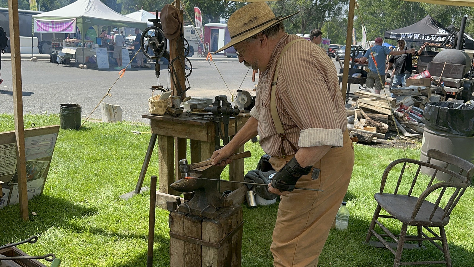 Hammering a steel bar into the rough shape of a hand forged nail.