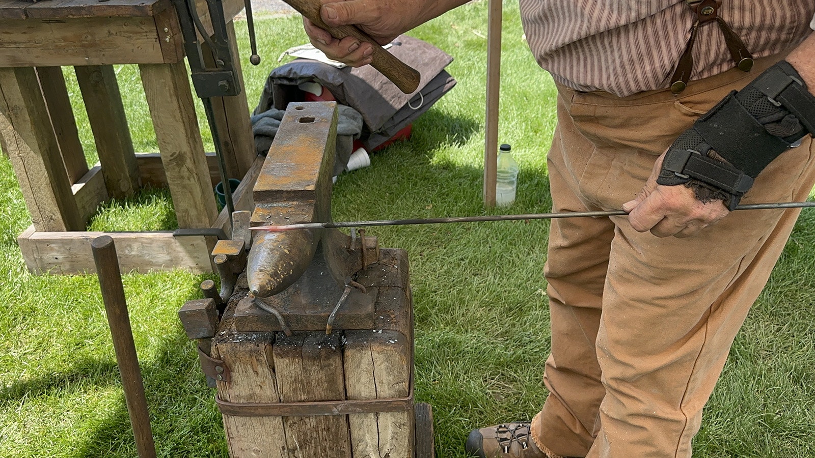 Hammering a steel bar into the rough shape of a hand forged nail.