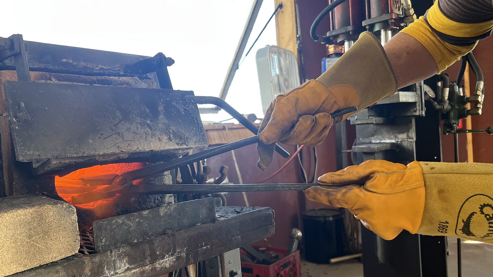 A propane-fueled forge in Audra Draper’s shop near Riverton quickly heats steel to glowing red.