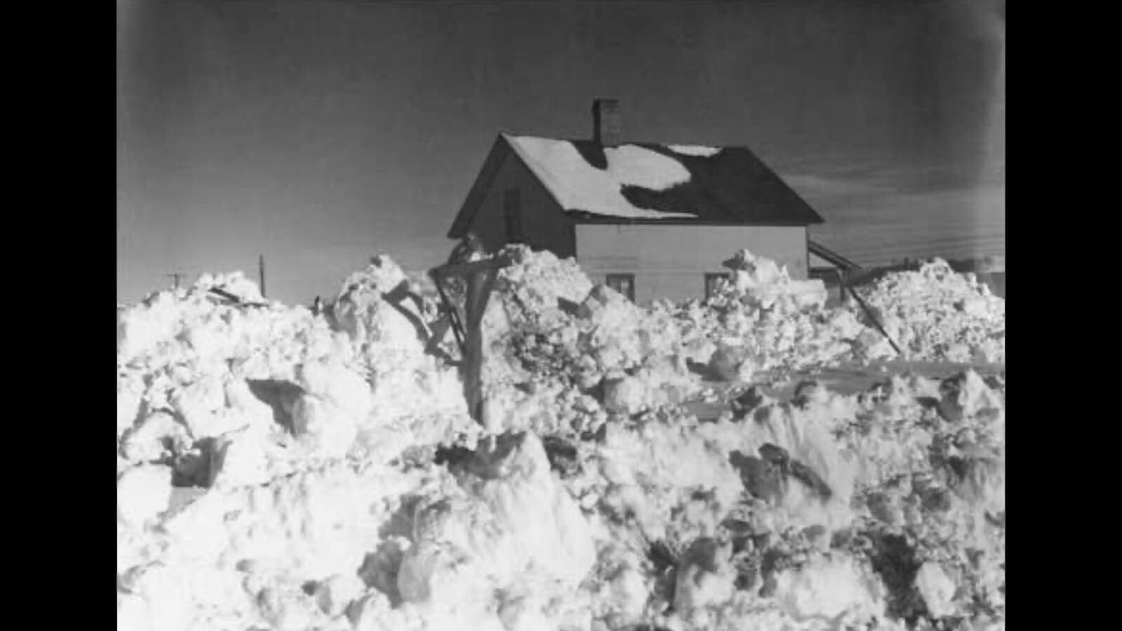 Unidentified house in Sweetwater County surrounded by piles of snow.