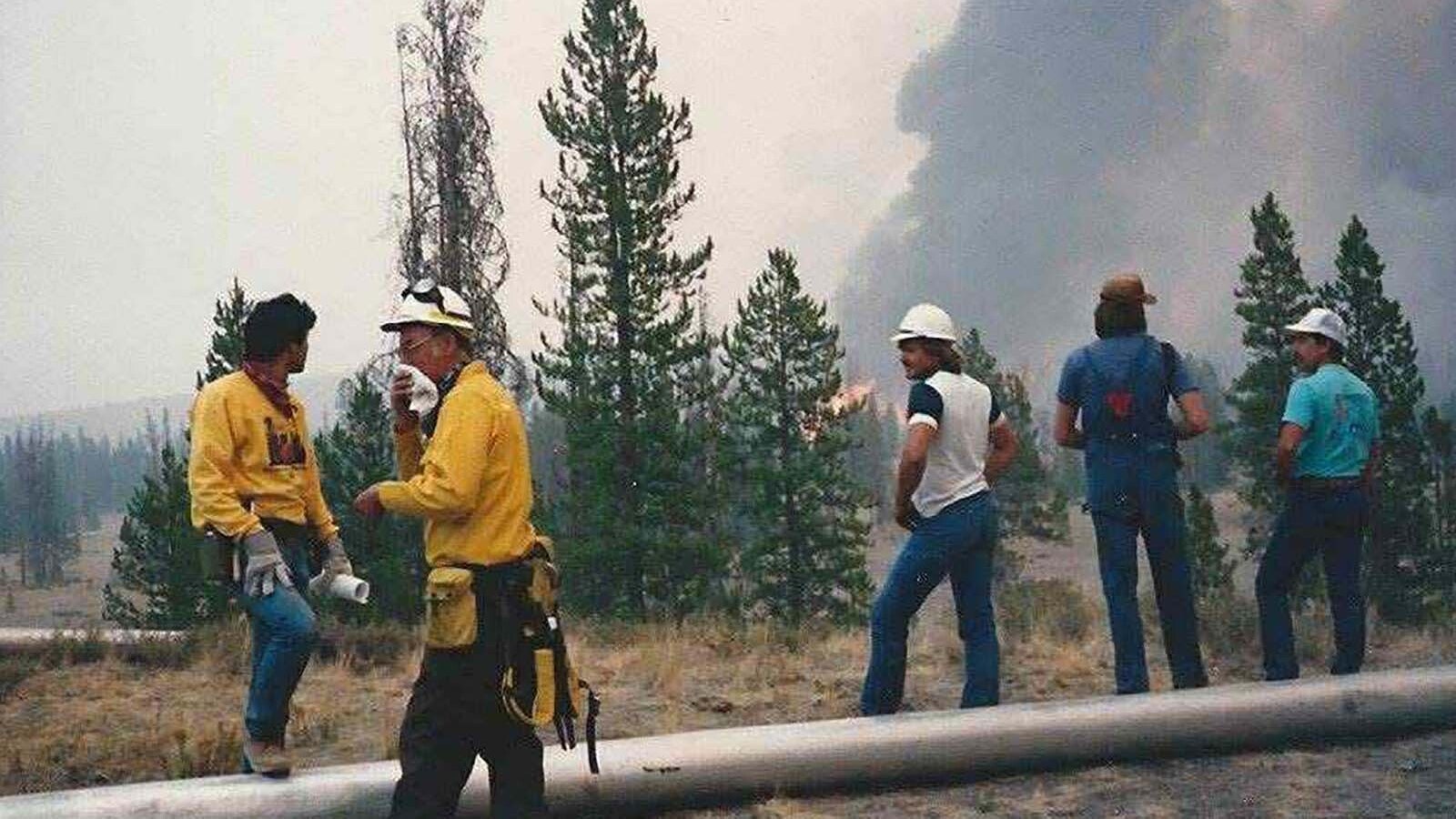 Farmers and fire crews work together to place irrigation pipes around West Yellowstone, Montana, in September 1988. When the still-raging Yellowstone fires turned toward West Yellowstone, fire crews asked local farmers if they could bring their irrigation pipes to form a defensive barrier around the gateway community and save it from the flames.