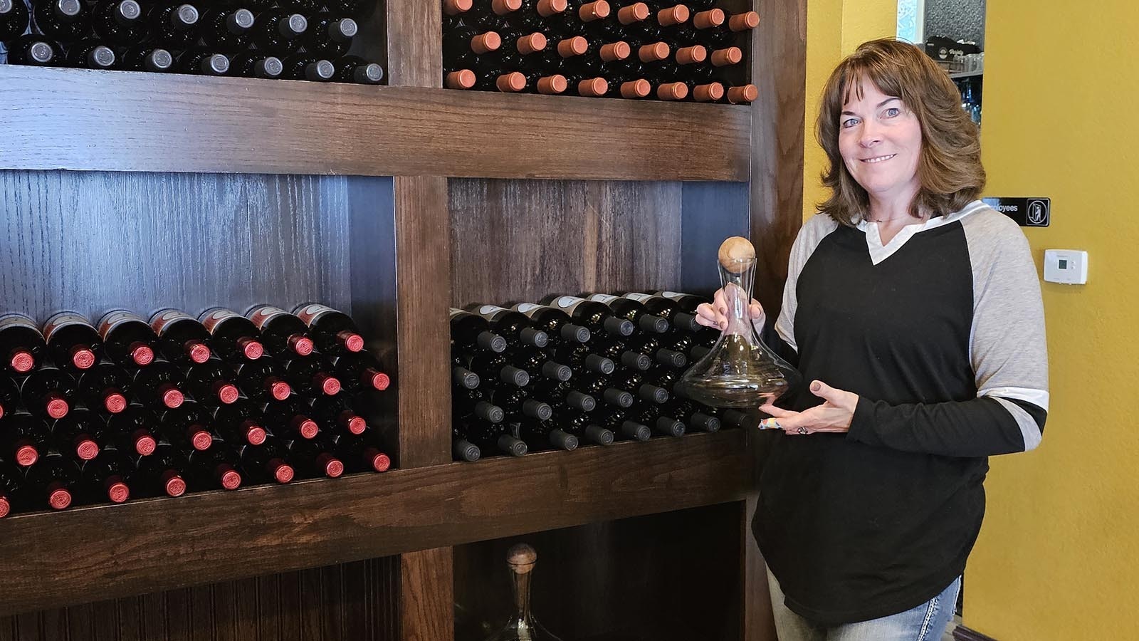 Virginia Erdmann with a wine flask at the Blue Stem Wine House in Cheyenne.