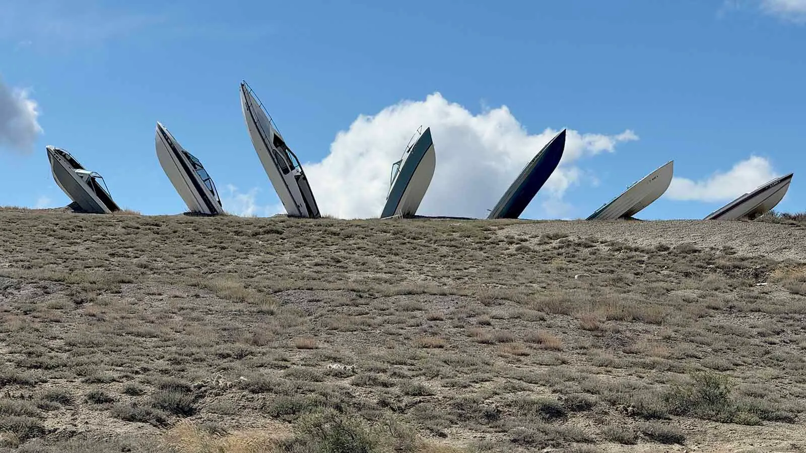 Hull’s Half Acre — many people call it “Boathenge” — gained notoriety when a row of half-buried boats appeared in the middle of nowhere outside Frannie, Wyoming, in 2020. The guy who put it there has a message for those who don’t like it: “Go to hell."