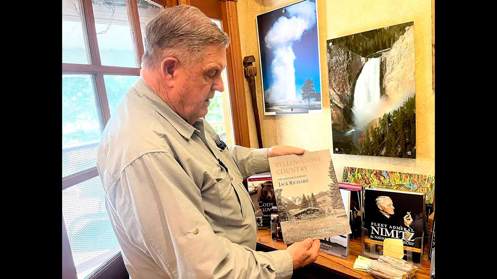 Bob Richard shows off one of his books at his Cody home in 2024.