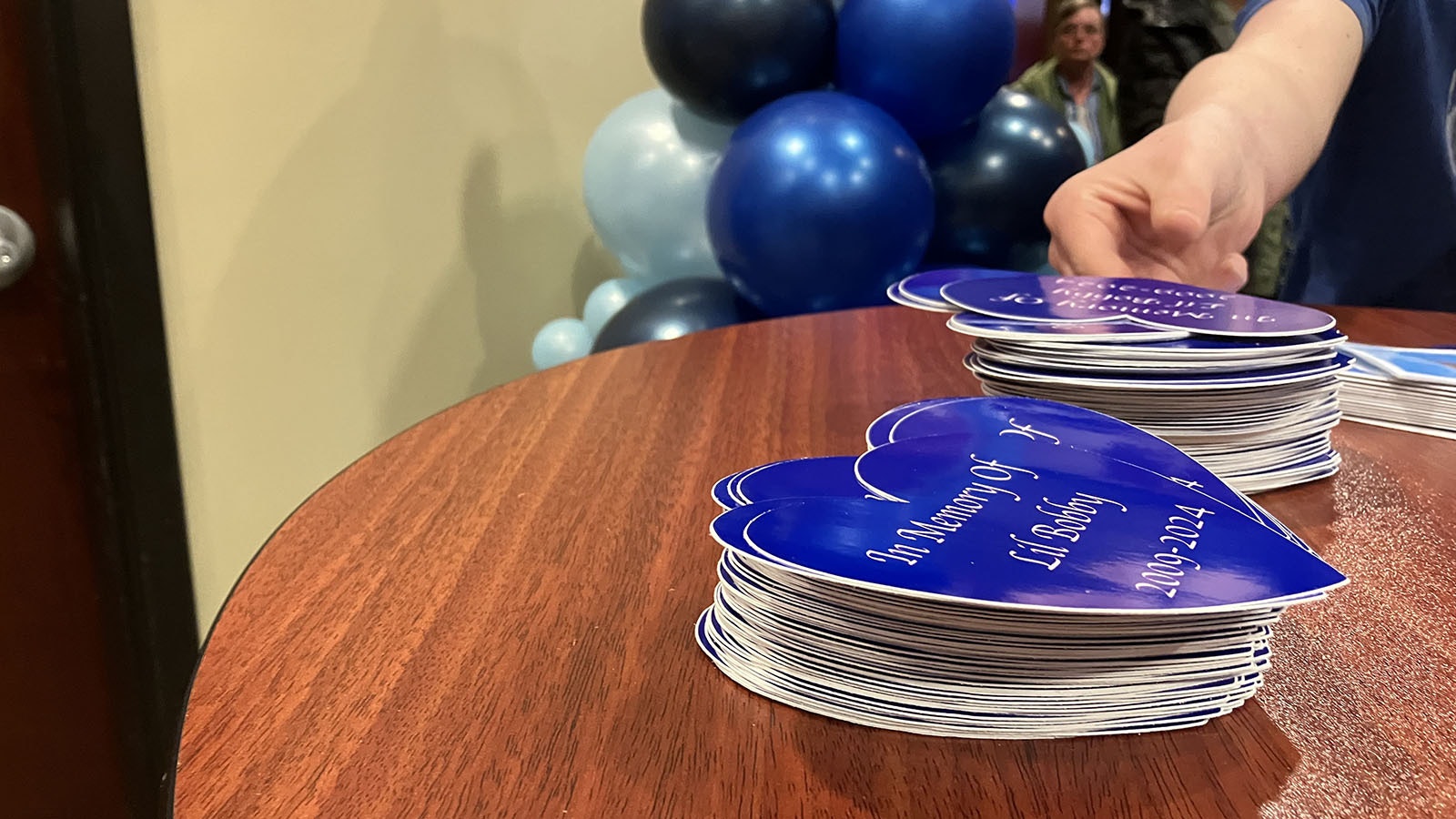 Blue Heart stickers that read “In Memory Of Lil Bobby” were offered to everyone who attended his funeral service.