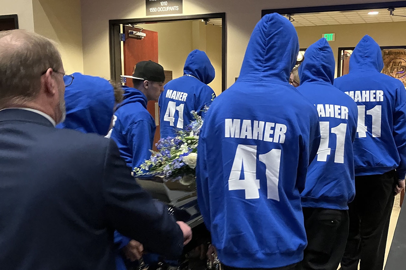 Bobby Maher’s pallbearers, who included his brothers and friends, all word blue hooded sweatshirts with his name and baseball jersey number, “41.”