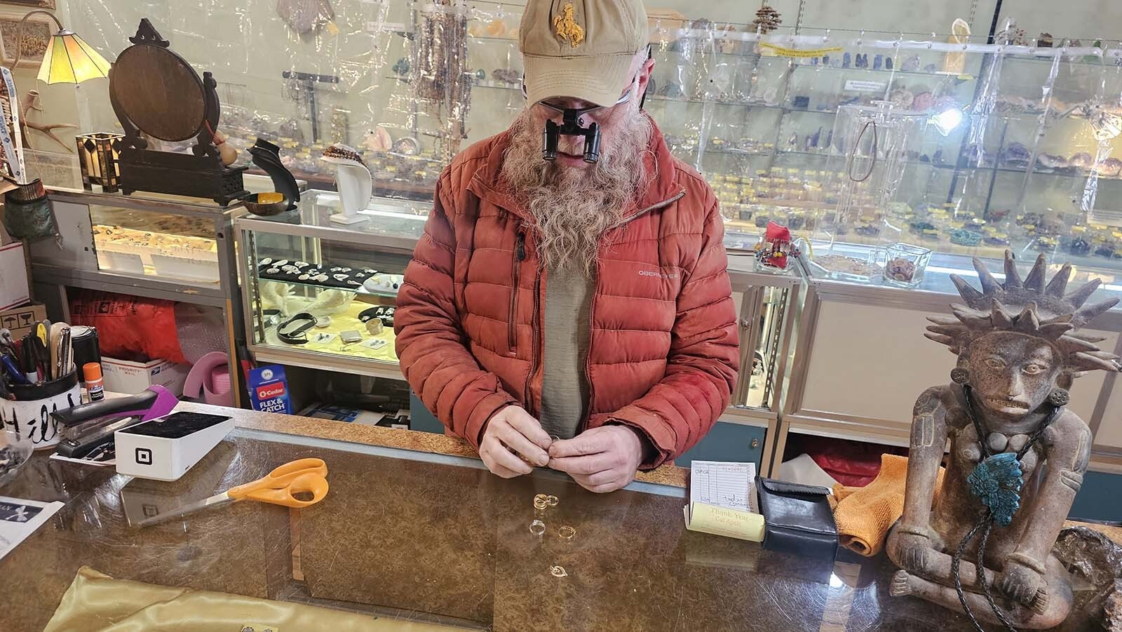 Brian Snyder looks over a set of rings to see how much they might be worth. Most of the time the jewelry brought in for sale is gold, but with silver prices spiking of late, more people are bringing that in to sell of late.