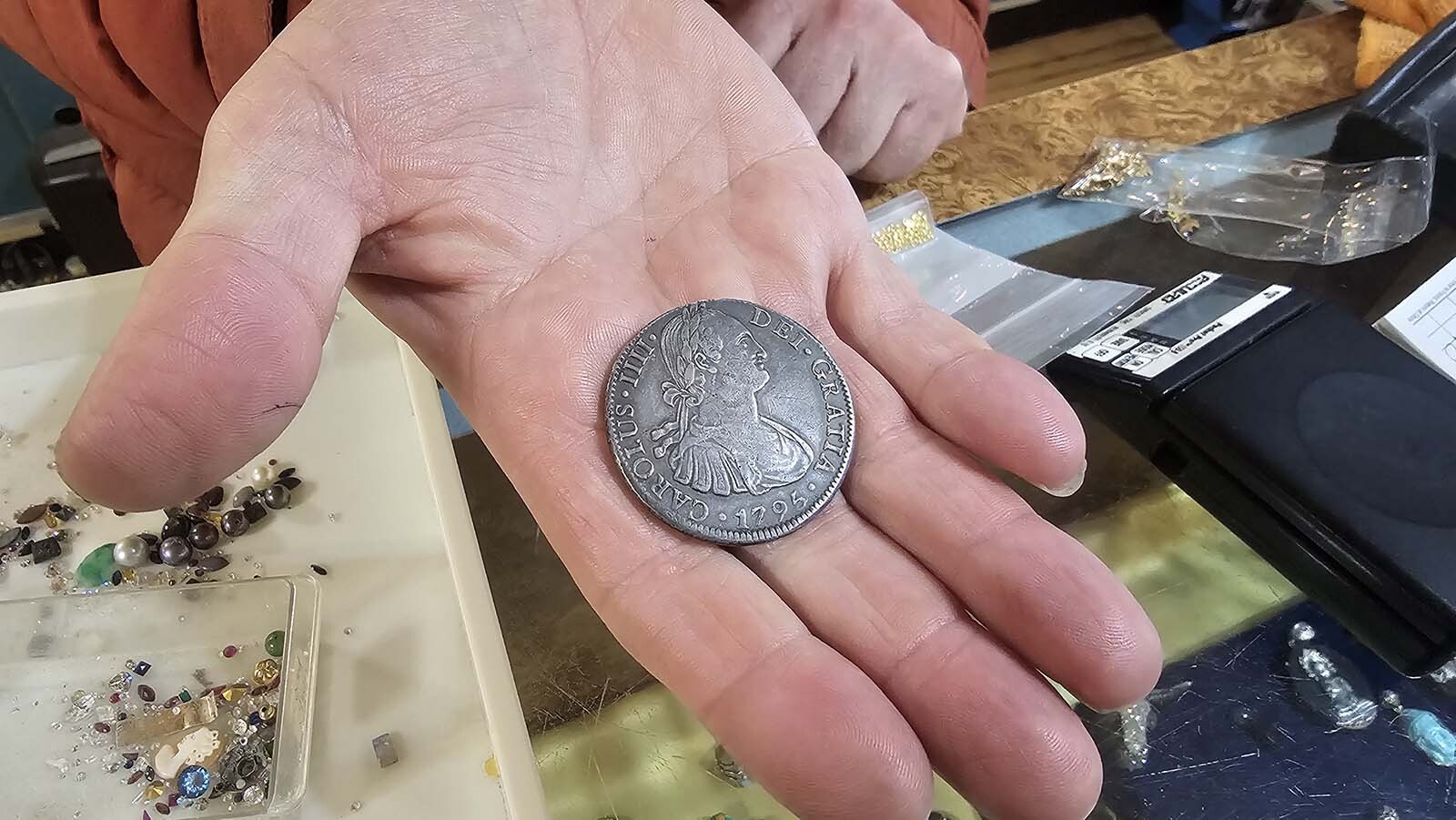 This silver coin is a piece of eight, so-named because it could be cut into eight pieces for trading. The coin's collectible value is still worth more than its mere metal value. The silver is worth $70 or so dollars, but as a collectible, the coin is worth about $600.