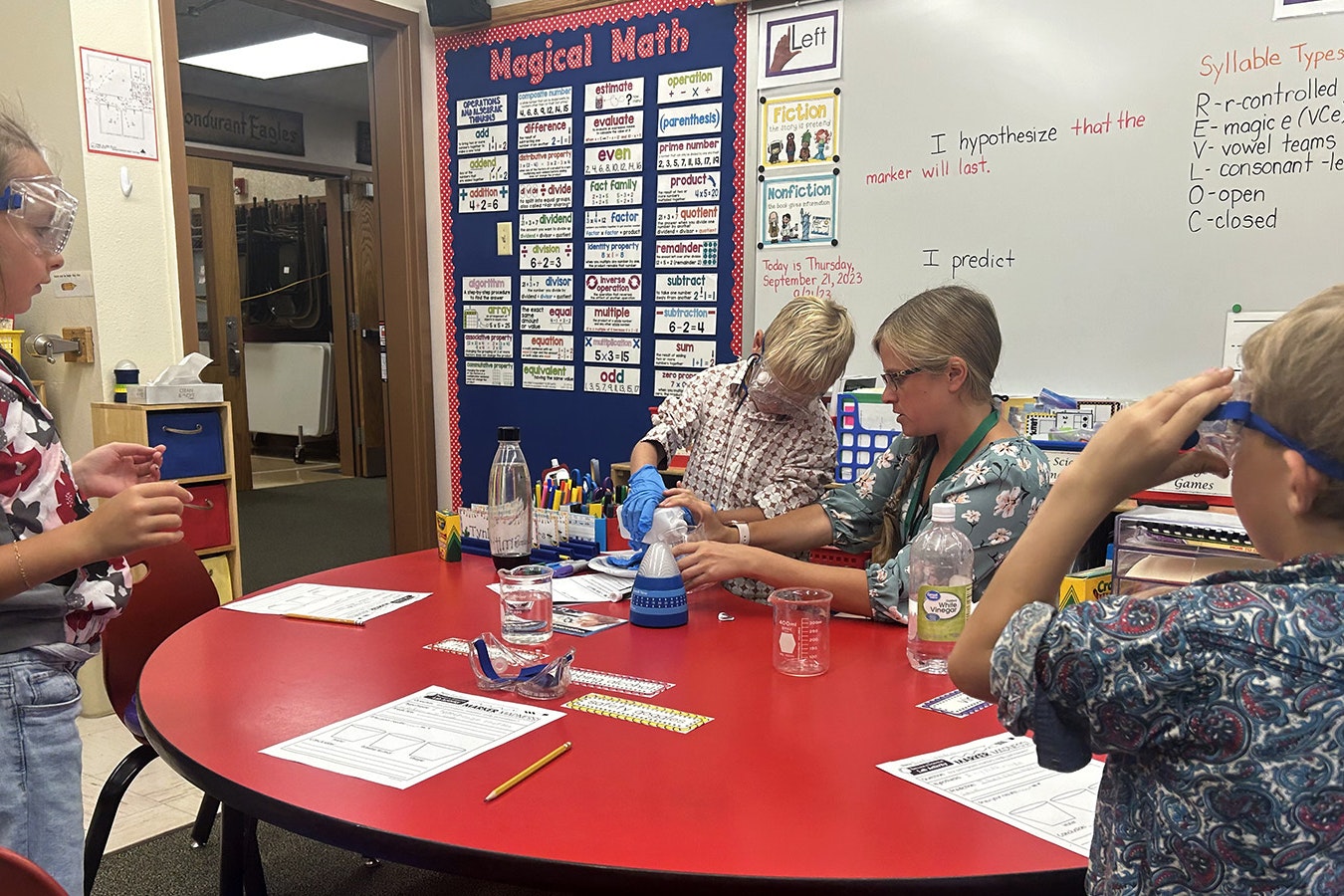 Students Jack Tolson, Tynlee Smith and Brady Saunders conduct a science experiment with their teacher Karin Unruh at Bondurant Elementary School.