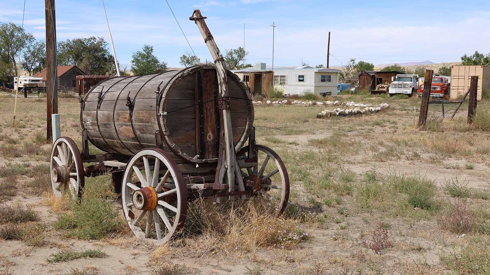 A barrel-like wagon that preceded the age of water trucks sits on a lot in Bonneville.