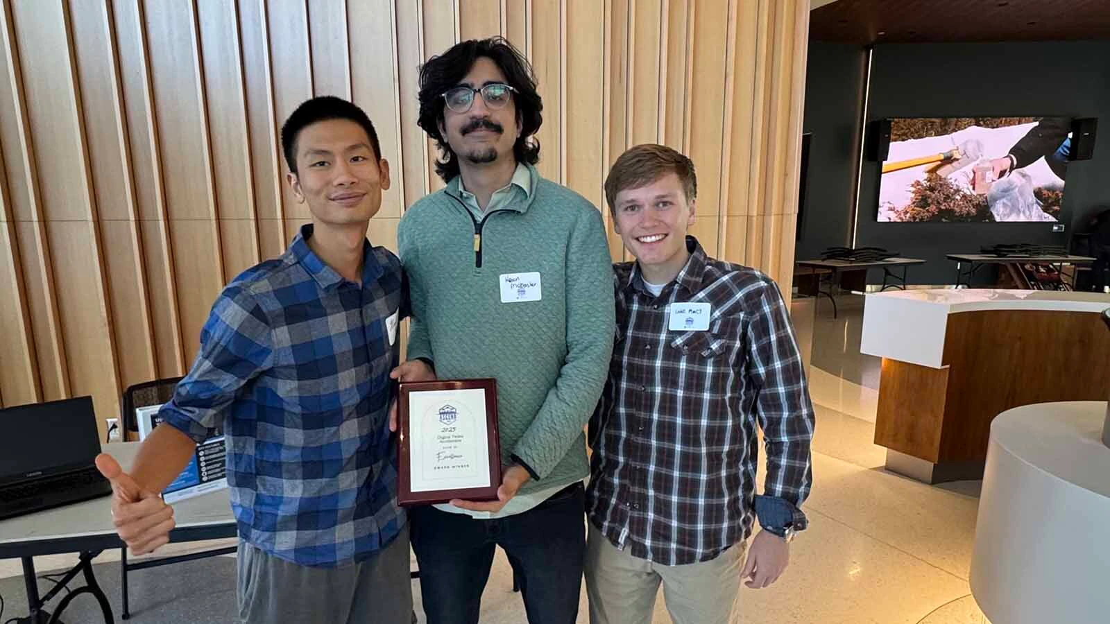 From left, Hung Quy poses with Power Theorys Keon Mobasher and Luke Macy just after winning an award from the NSF ASCEND Digital Twins Accelerator Program.