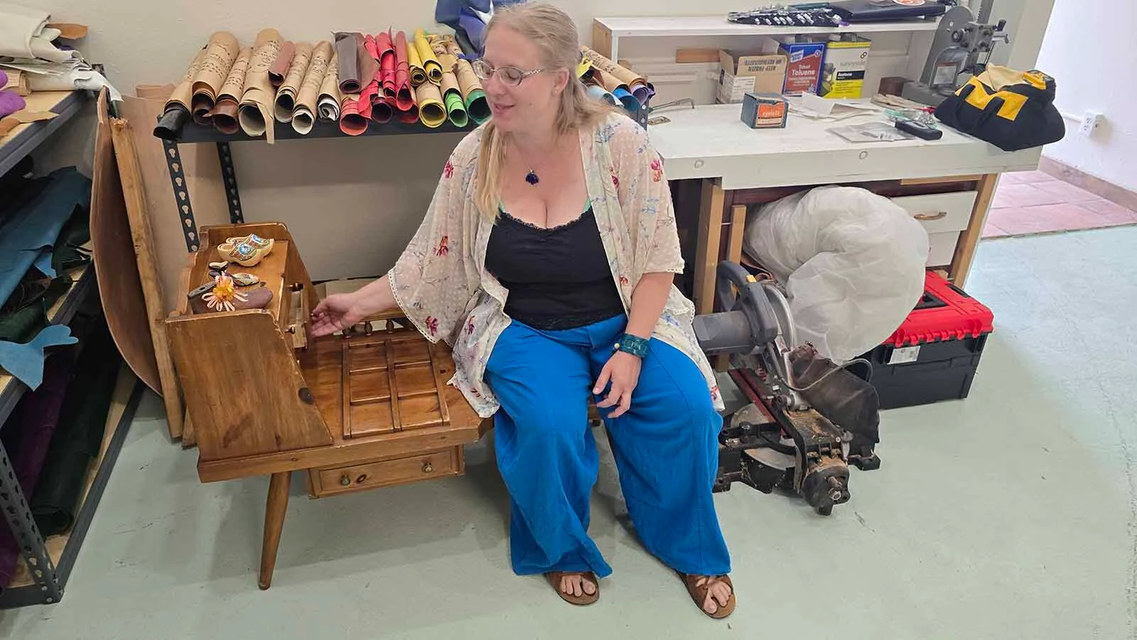 Alyssa Lenell-White Photo sits on the cobbler's table her husband gave her for her new, custom bootmaking store in Cheyenne.