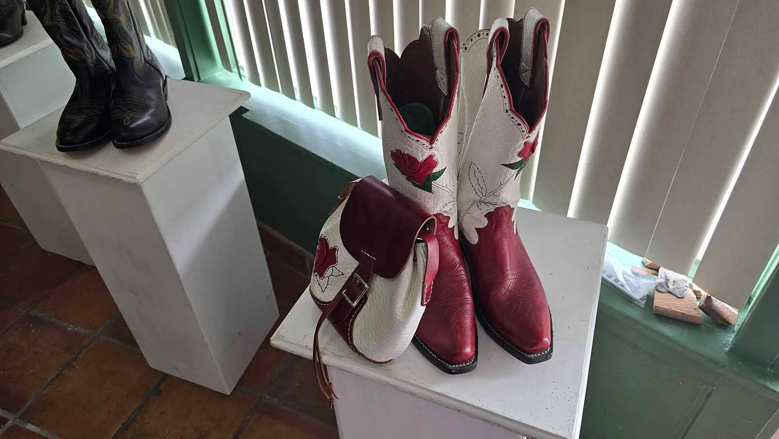 A pair of boots with matching purse at Alyssa Lenell-White's new custom bootmaking shop in Cheyenne.