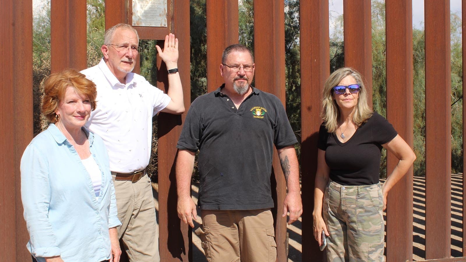 Wyoming Senate candidate Kim Withers, from left, state Reps. Jon Conrad, R-Mountain View, Tony Niemec, Sen. Stacey Jones, R-Rock Springs, stand near a plaque commemorating the southern border wall built by former President Donald Trump.