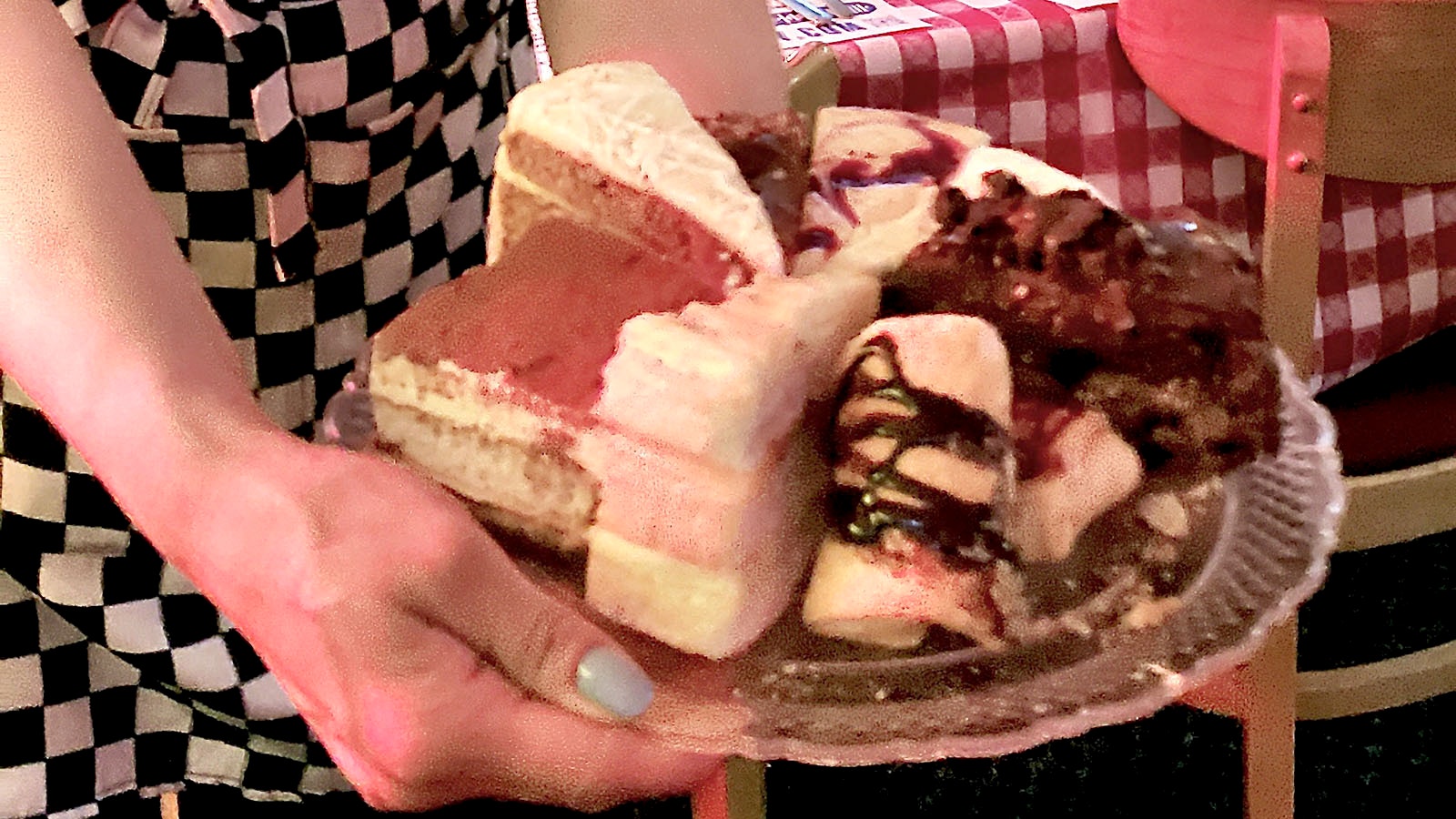 A server presents a tray of desserts.