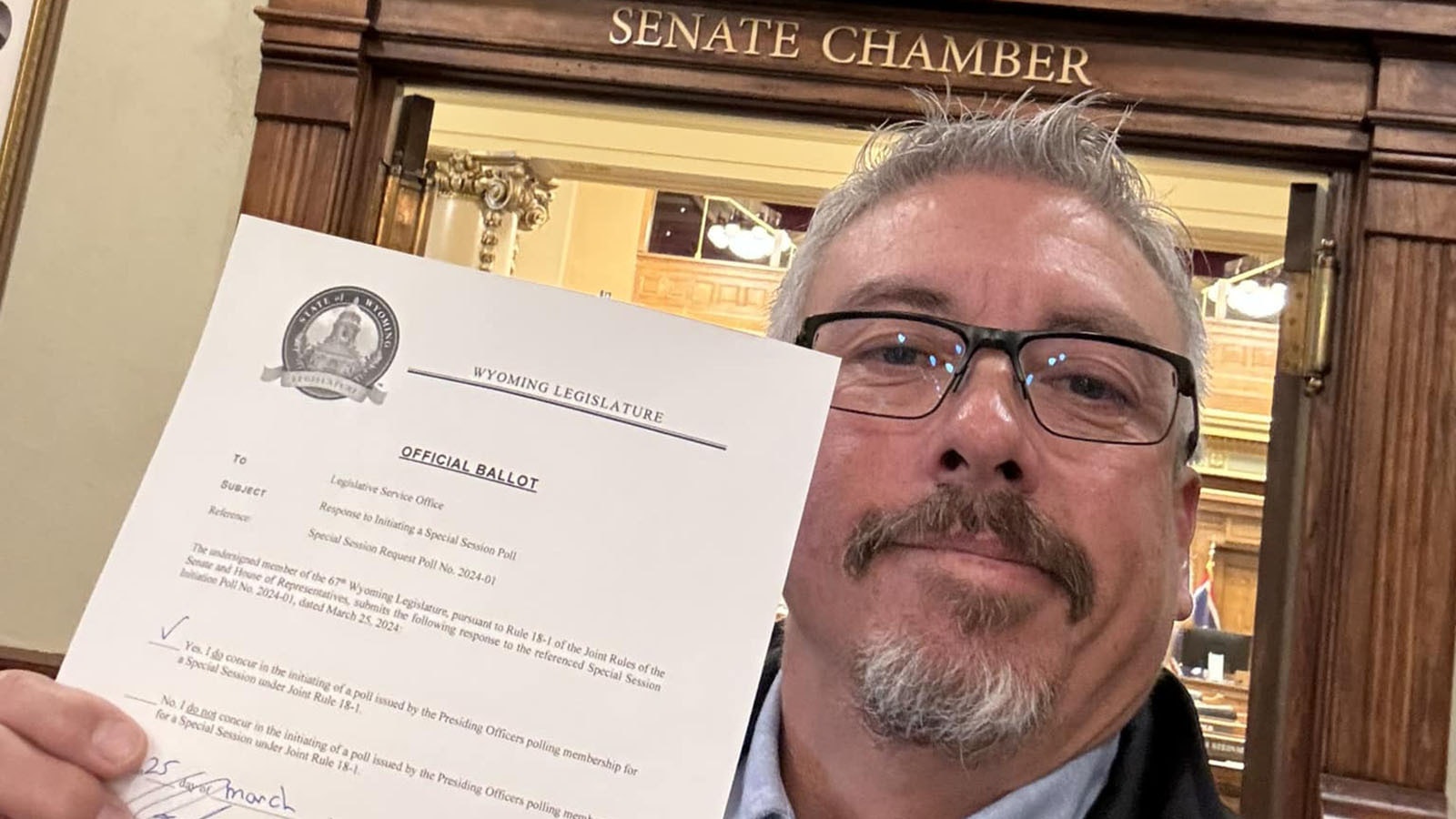 State Sen. Anthony Bouchard, R-Cheyenne, shows his ballot in favor of calling a special session of the Legislature.