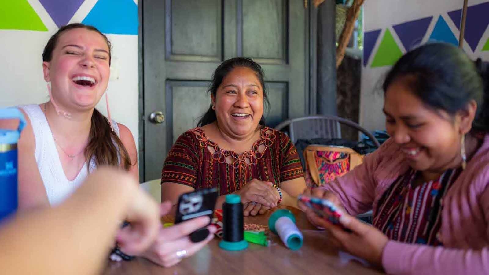 Anna, a Bought Beautifully intern through Sherian College and the Scott Foundation, works with Lydia, center, during a trip to Guatemala.