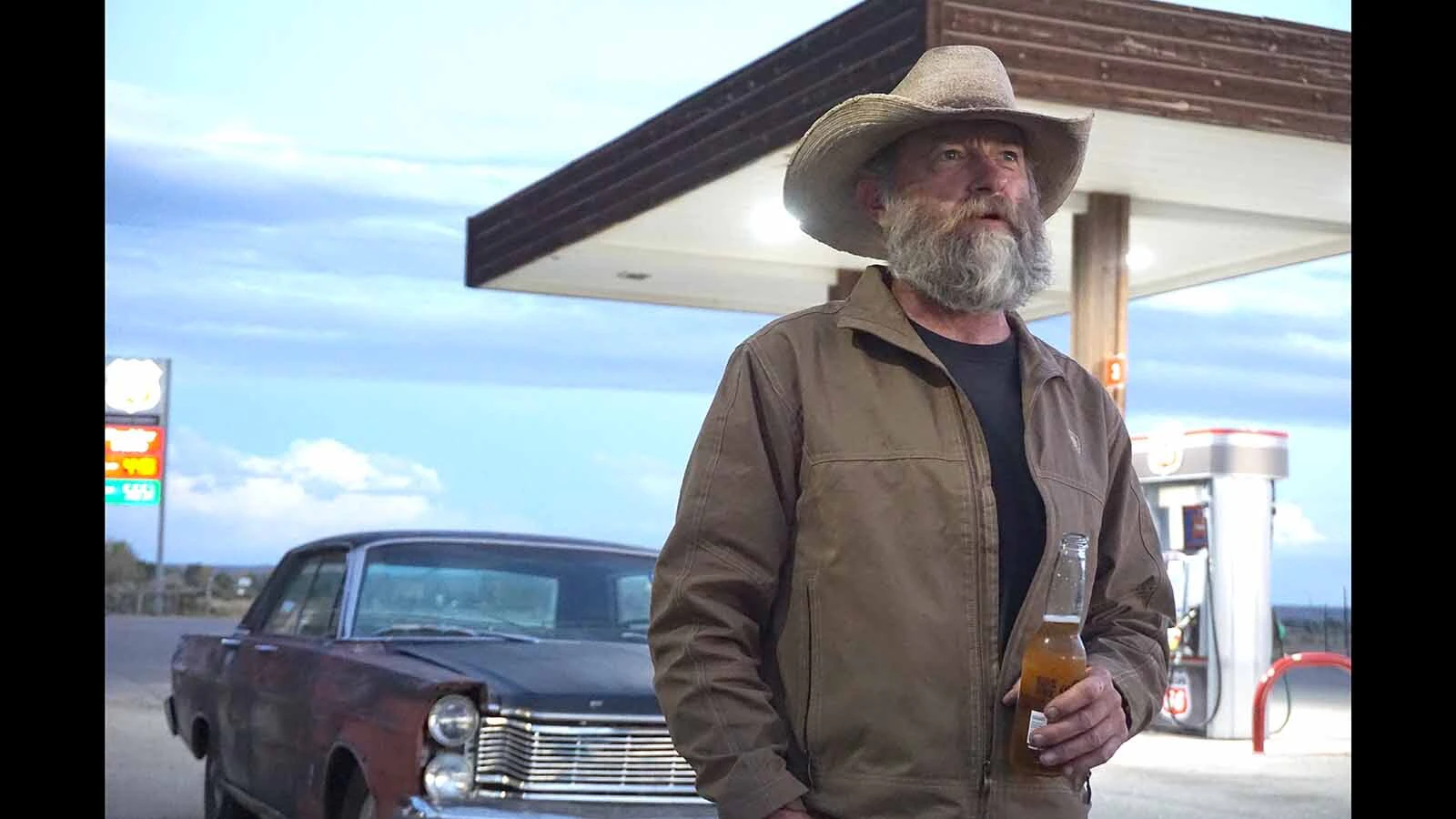 Third-generation Boulder Bar owner Burke Steele enjoys a cigar, a beer and his rusted 1965 Ford Galaxie when not running the bar.