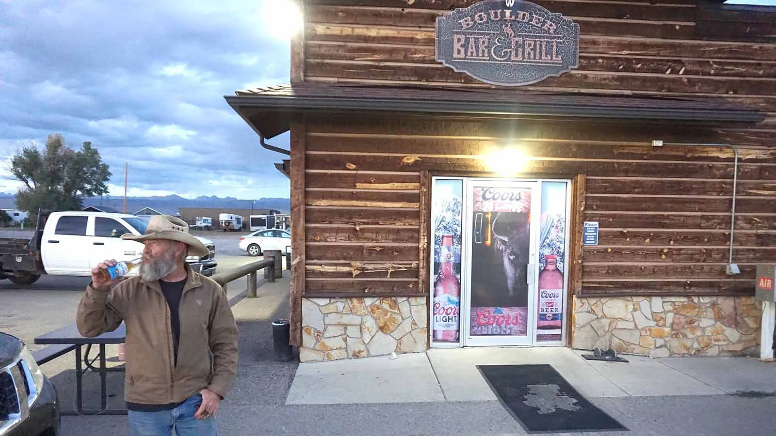Boulder Bar bartender Clayton looks like a man who's paid a price for the life he's lived. His eyes are filled with fatigue, and he’s missing most of his teeth from a former life in competitive rodeo.